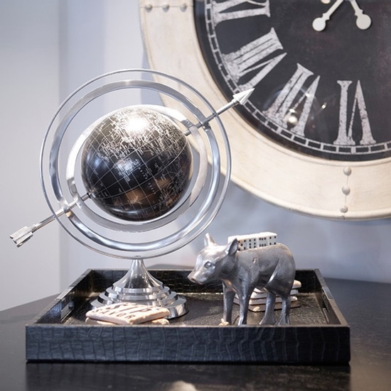 Animal Figurine and Globe in a Black Wooden Tray Kept on Table Besides Analog Wall Clock