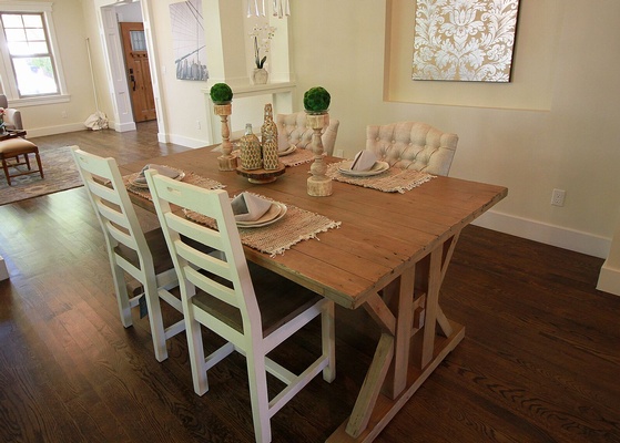 Brown Wooden Dining Table With Four Padded Chairs Inside Room with Beige Painted Walls
