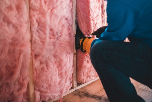 Person insulating the wall.