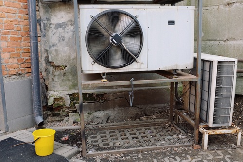 An air conditioner near a wall.