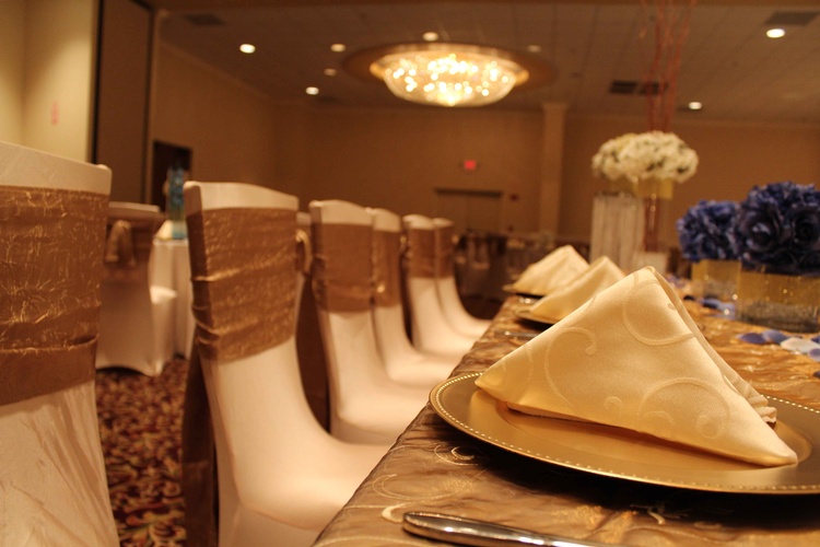 Minimalist table setting with white plates, geometric gold flatware organized by Houston Event Planning