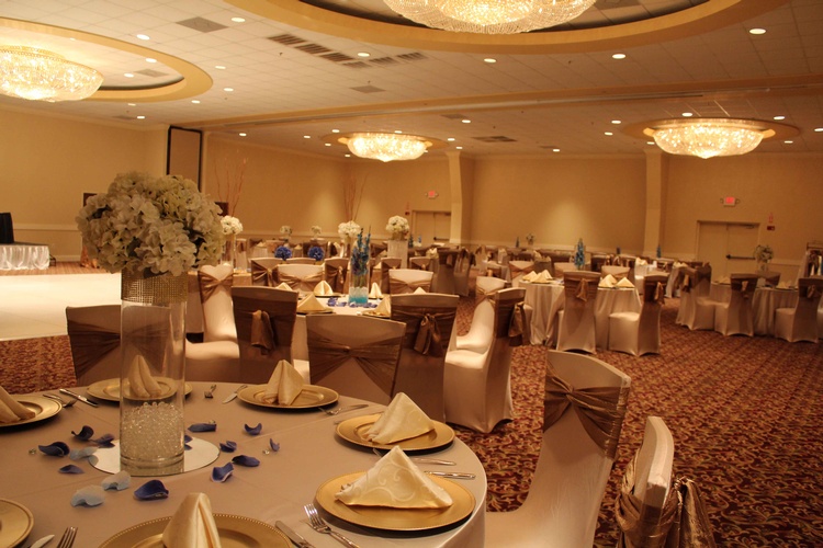 Table and chair set up for a wedding reception with elegant centerpieces organized by Houston Event Planning