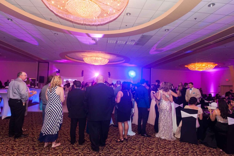 Prom-goers enjoying a night of dancing under a disco ball organized by Houston Event Planning