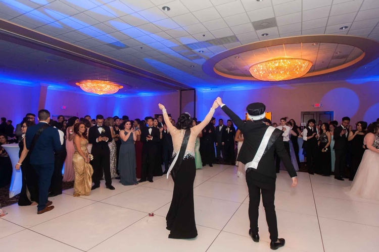Prom King and Queen crowned on stage in front of their classmates captured by Houston Event Planning