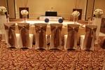 Table setting for a modern party with simple white plates and candle holders organized by Houston Event Planning