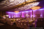 Beautiful wedding reception table setup with chandeliers and drapery done by Houston Event Planning