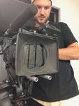 Videographer at Merlin Productions LLC handling a video camera with care