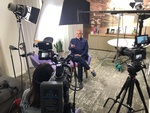 Behind the camera perspective of an interview being shot in an office