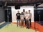 People posing for a picture in a studio after the shoot