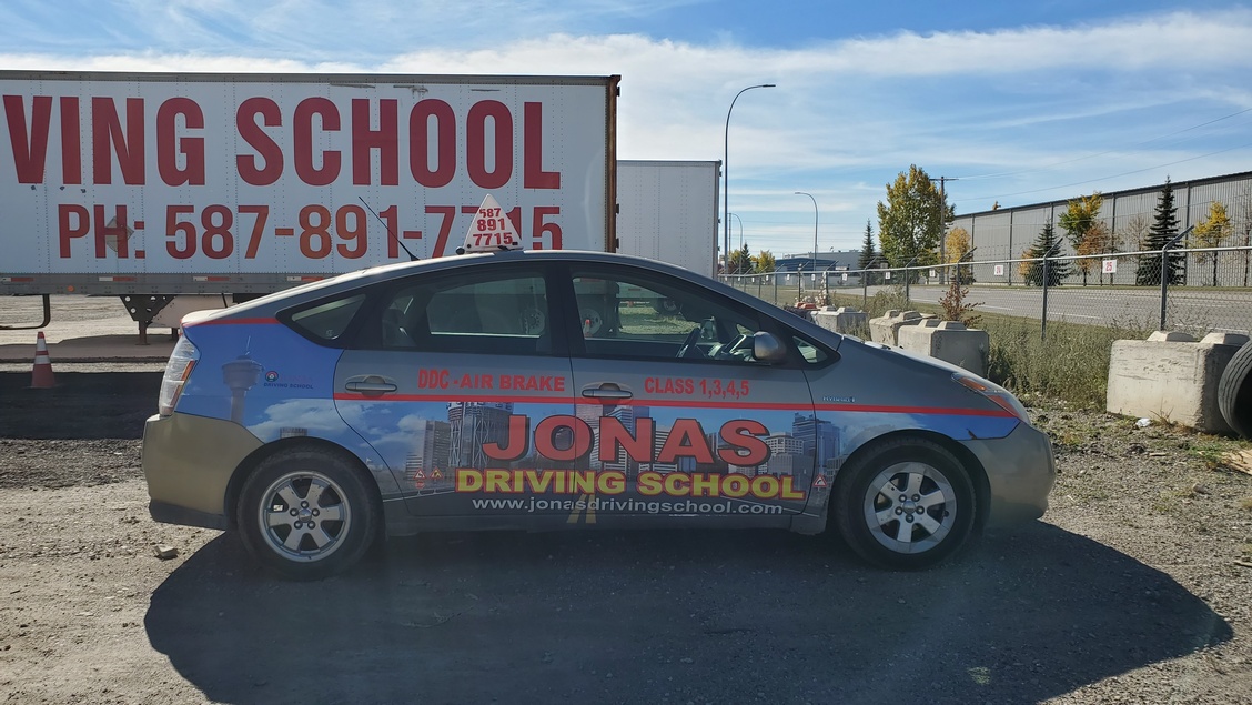 Car used at Jonas Driving Shool with logo on the car.