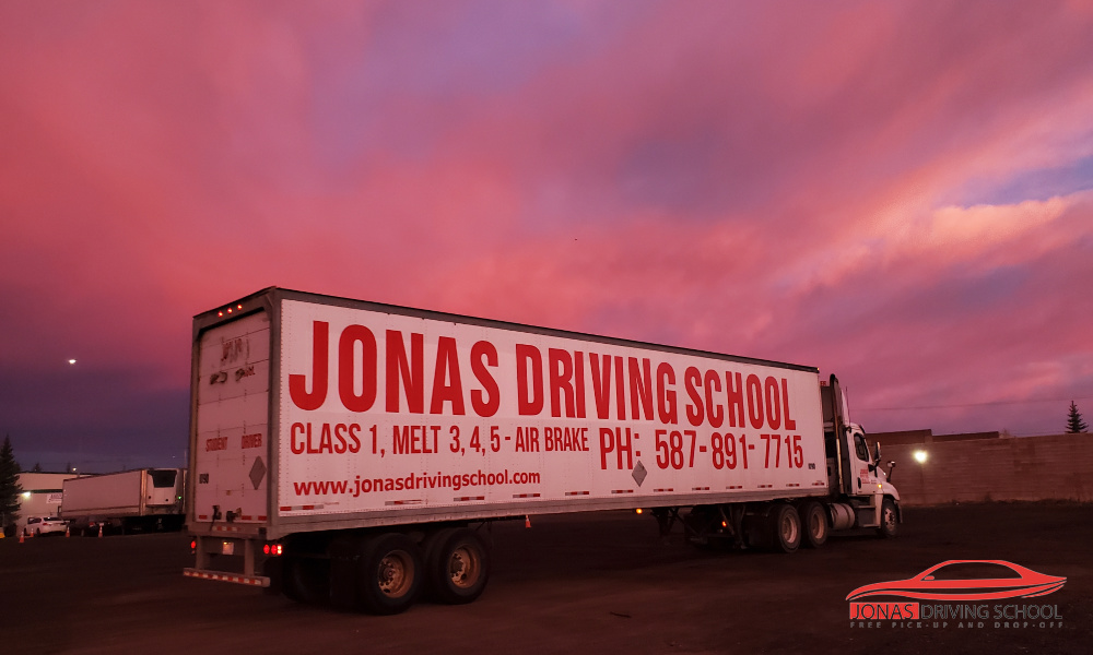 Jonas Driving Schoolsighn on a semi truck and trailer