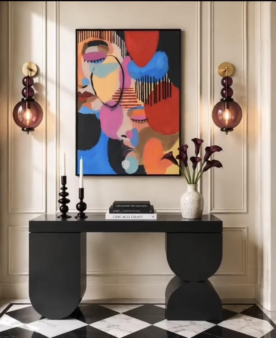 Entryway with decorative ceiling fixture and table lamp