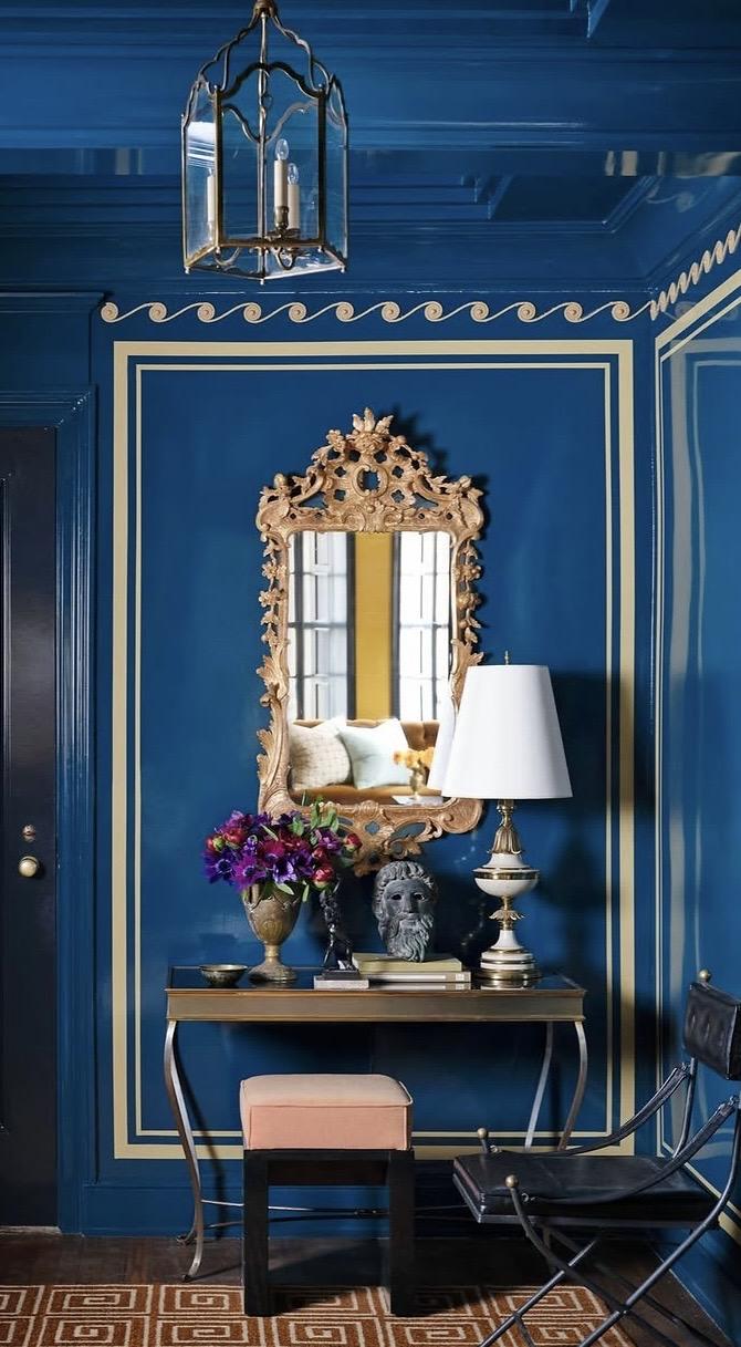 Foyer with modern art above an antique console