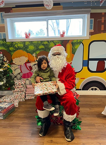 Santa giving Milan gifts for christmas at HIDE ‘n' SEEK DAYCARE - Licensed Childcare and Preschool in Brampton, Ontario
