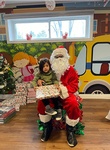Santa giving Milan gifts for christmas at HIDE ‘n' SEEK DAYCARE - Licensed Childcare and Preschool in Brampton, Ontario