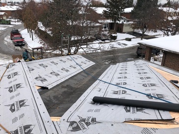 Roof Repairing work carried out by expert roofers in the snowy area by Imperial Roofs and Aluminum