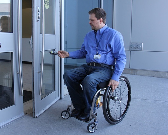 A man in wheelchair demonstrating Integral Konnect's access control systems for disabled individuals in Richmond Hill.