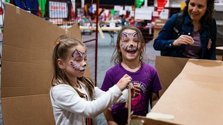 Photo taken by Darkstrand Visuals of two girls getting beautiful designs painted on their faces during a children's event