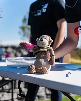 A person showcasing a monkey doll at Bash 2022 Event photo captured by Darkstrand Visuals