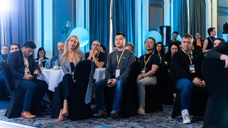 Picture of attendees at an Opus event paying attention to the speaker captured by Darkstrand Visuals