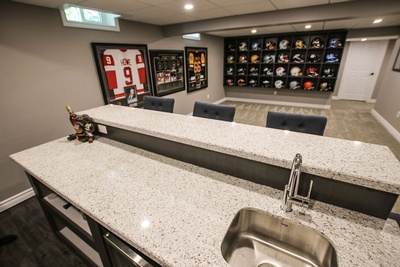 Basement Renovation with an embedded Stacked Football Cabinet by Kreekside Construction Group Inc.