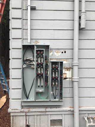 Replacing an outdated main service panel with a more modern and efficient model