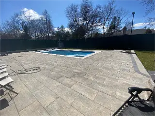 Pavers Installation around pool area by Green Crew Contracting Inc for elegant look