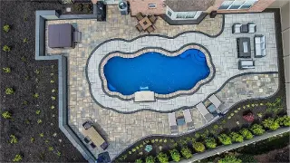 Pavers Installation around pool area by Green Crew Contracting Inc for excellent look