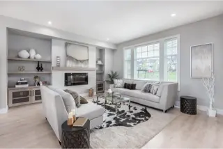 Step into the luxurious white living room interior of Towns At Trafalgar, a townhome collection by Noura Homes