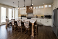 Four lighted pendant lamps above Dining Table - Luxury Kitchen Design in Kansas City by R Designs, LLC