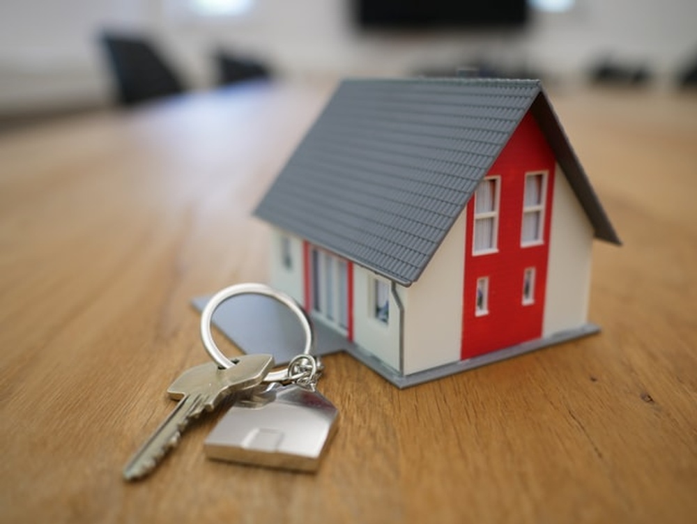 A model of a house and a set of keys.