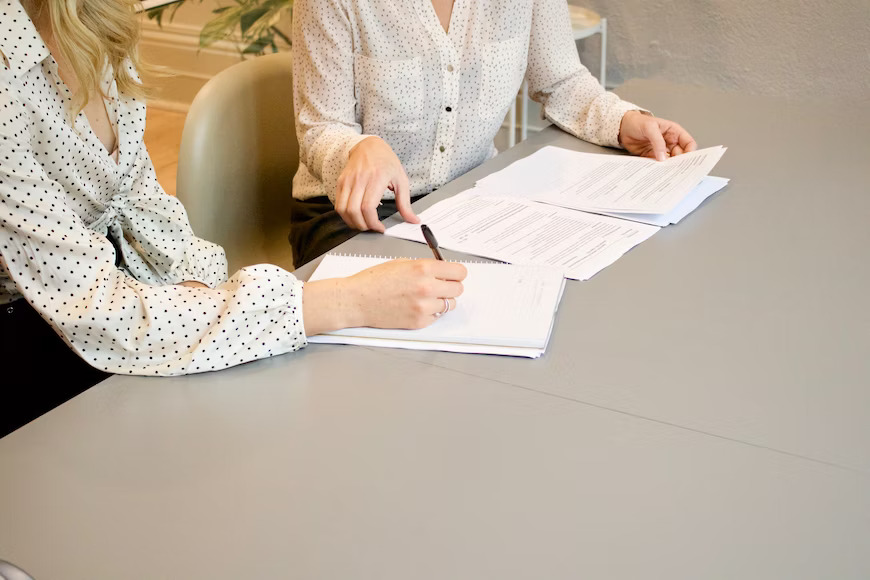 Two women working on paperwork