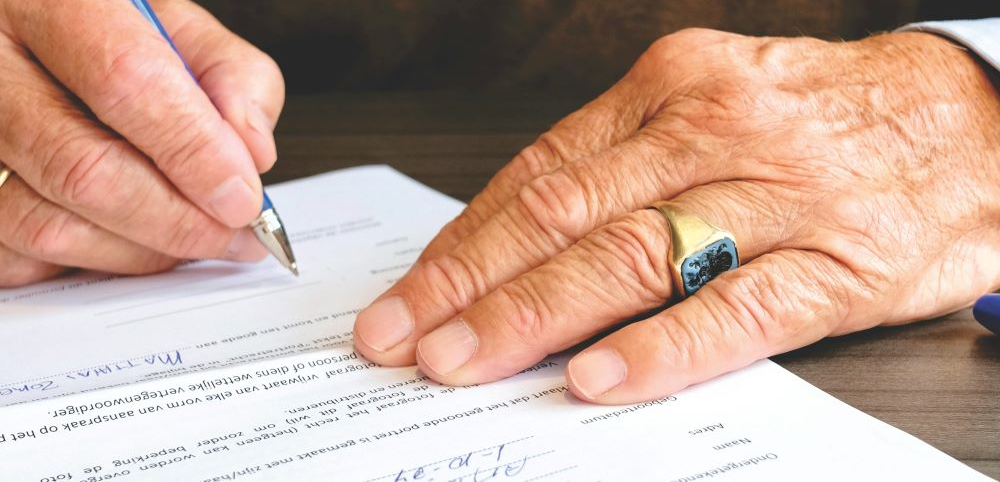 A man signing a document