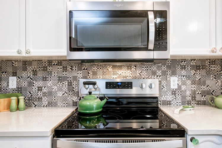 THE NEW BACKSPLASH ADDED GREAT CONTRAST TO THE WHITE COUNTER AND CABINETS , IT BRINGS NICE COMBINATION WITH THE APPLIANCES.