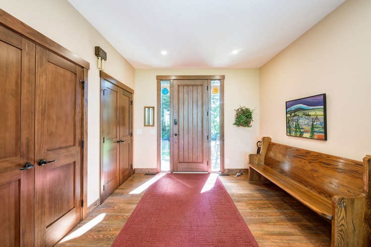 THIS SPACIOUS FOYER IS THE PERFECT TRANSITION BETWEEN THE EXTERIOR ELEMENTS AND THE WARM INTERIOR, VERY INVITING AND WITH PLENTY OF ROOM TO STORE THE COATS.