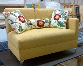 Upholstered Loveseat with Three Multicolored Floral Throw Pillows