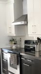 Stainless Steel Kitchen Hood Between Cabinets - Kitchen Interior Design Whitefish by INTERIORS by NICOLE