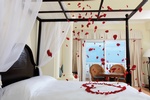 Bed decorated with rose petals for honeymoon at Grand Bahia Principe Jamaica 