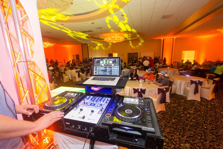 Corporate Event venue with stage and lighting set up organized by Houston Event Planning