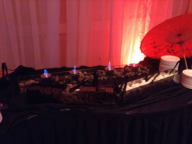 Festive decor with shimmering red and gold lights for a 60th birthday party organized by Houston Event Planning