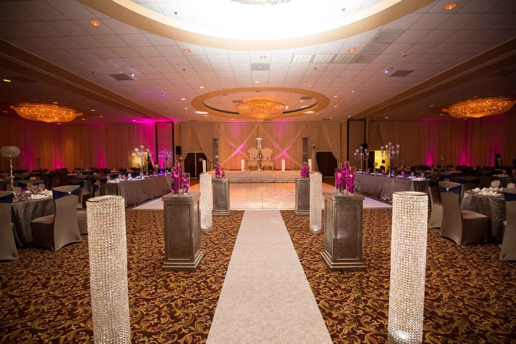 Reception venue with decorative lighting and floral arrangements done by Houston Event Planning