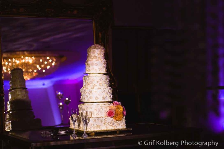 Wedding cake with intricate design and topper at the reception done by Houston Event Planning