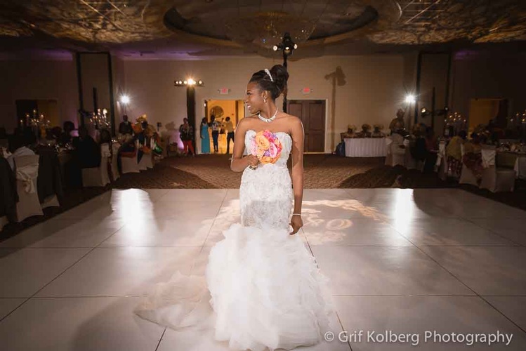 Bride's wedding dress and holding bouquet of flowers captured by Houston Event Planning