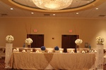 Table setting with decorative centerpieces and party favors for a party organized by Houston Event Planning