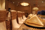 Minimalist table setting with white plates, geometric gold flatware organized by Houston Event Planning