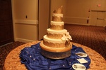 Beautifully decorated cake with icing and flowers on festive table setup organized by Houston Event Planning