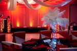 Table setting with red and gold centerpieces and place cards for a birthday party by Houston Event Planning
