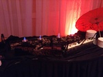 Festive decor with shimmering red and gold lights for a 60th birthday party organized by Houston Event Planning