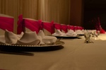 Decorated Quinceañera table with embroidered tablecloths and matching napkins done by Houston Event Planning