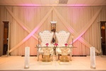 Decorated chairs set up for the bride and groom done by Houston Event Planning